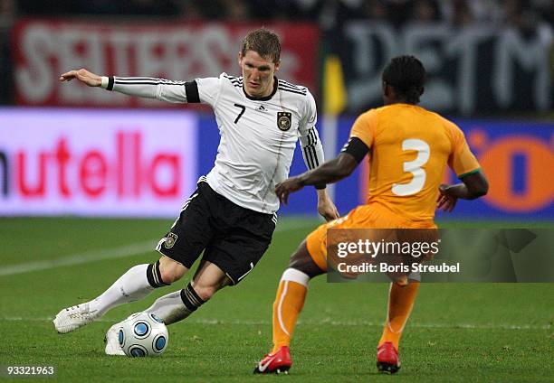 Bastian Scheinsteiger of Germany battles for the ball with Arthur Boka of Ivory Coast during the International Friendly match between Germany and...