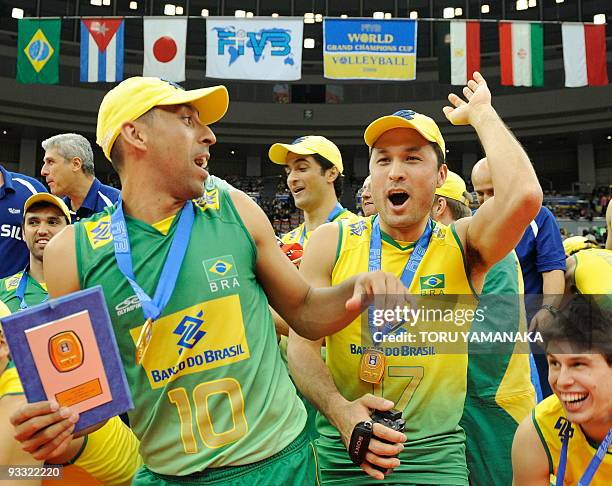 Brazilian Sergio Dutra Santos , Marlon Yared and other teammates jubilate during the award ceremony at the men's Grand Championship Cup volleyball...