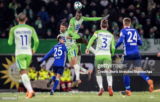 Joshua Guilavogui of VfL Wolfsburg and Jeffrey Bruma of VfL Wolfsburg jump for a header during the Bundesliga match between VfL Wolfsburg and FC...