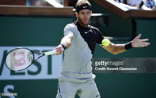 Juan Martin Del Potro of Argentina hits a forehand against Milos Raonic of Canada during the semifinal match on Day 13 of the BNP Paribas Open on...