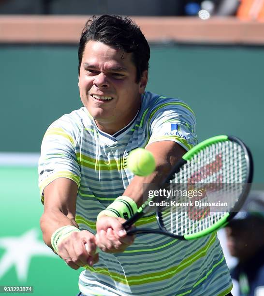 Milos Raonic of Canada hits a backhand against Juan Martin Del Potro of Argentina during the semifinal match on Day 13 of the BNP Paribas Open on...