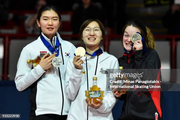 Suk Hee Shim of Korea Min Jeong Choi of Korea and Kim Boutin of Canada hold up their medals after completing women's 1500 meter Finals during the...