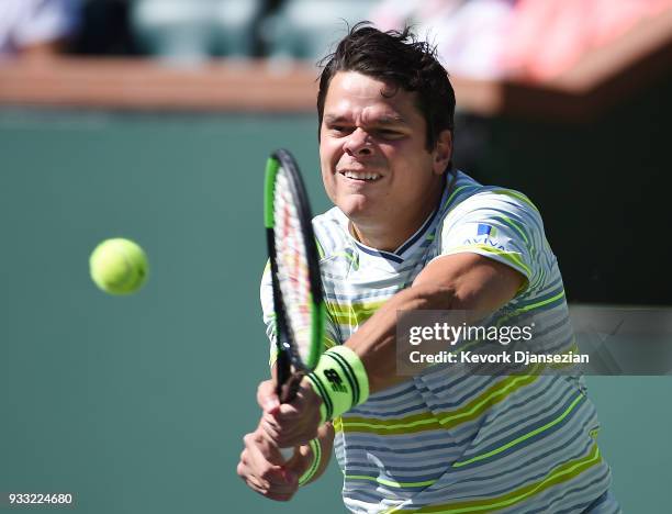 Milos Raonic of Canada hits a backhand against Juan Martin Del Potro of Argentina during the semifinal match on Day 13 of the BNP Paribas Open on...