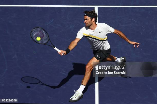 Roger Federer of Switzerland returns the ball to Borna Coric of Croatia during the semifinal match at BNP Paribas Open - Day 13 on March 17, 2018 in...