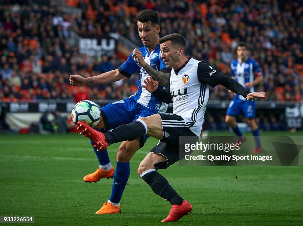Jose Luis Gaya of Valencia competes for the ball with Hernan Perez of Alaves during the La Liga match between Valencia and Deportivo Alaves at...