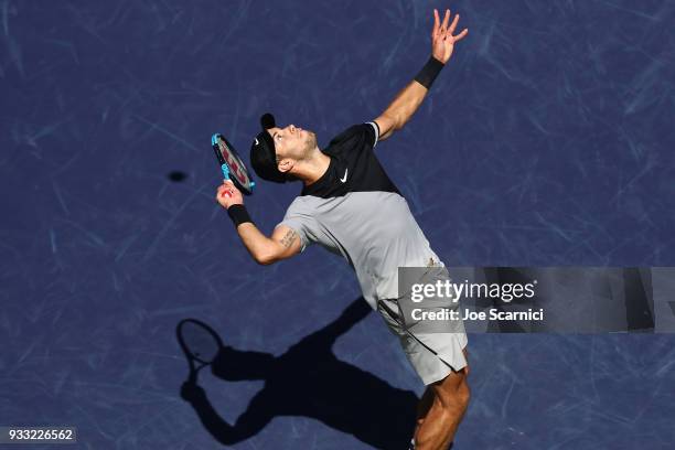 Borna Coric of Croatia serves to Roger Federer of Switzerland during their semifinal match at BNP Paribas Open - Day 13 on March 17, 2018 in Indian...