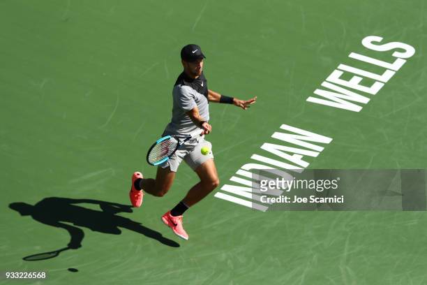 Borna Coric of Croatia returns a shot to Roger Federer of Switzerland during their semifinal match at BNP Paribas Open - Day 13 on March 17, 2018 in...