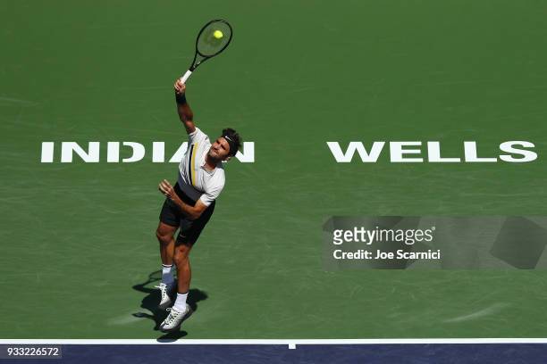 Roger Federer of Switzerland serves to Borna Coric of Croatia during the semifinal match at BNP Paribas Open - Day 13 on March 17, 2018 in Indian...