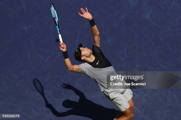 Borna Coric of Croatia serves to Roger Federer of Switzerland during their semifinal match at BNP Paribas Open - Day 13 on March 17, 2018 in Indian...