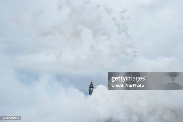 The image has been taken with a tilt-shift lens) The smoke hides the buildings of Plaza del Ayuntamiento during the 'Mascleta', an explosive barrage...