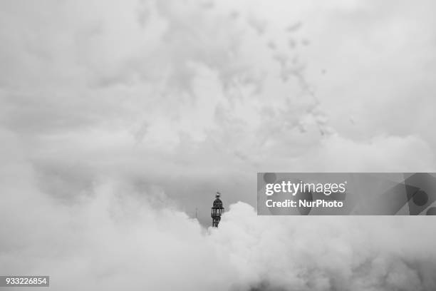 The image has been taken with a tilt-shift lens and converted to black and white) The smoke hides the buildings of Plaza del Ayuntamiento during the...