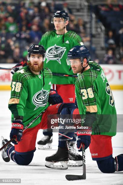 David Savard, Mark Letestu and Boone Jenner, all of the Columbus Blue Jackets, wear special green jerseys for St. Patrick's Day during warm ups...