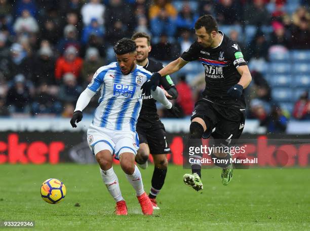 Elias Kachunga of Huddersfield Town is tackled by Luka Milivojevic of Crystal Palace during the Premier League match between Huddersfield Town and...