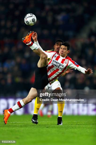 Hirving Lozano of PSV competes for the ball with Jerold Promes of VVV Venlo during the Dutch Eredivisie match between PSV Eindhoven and VVV Venlo...