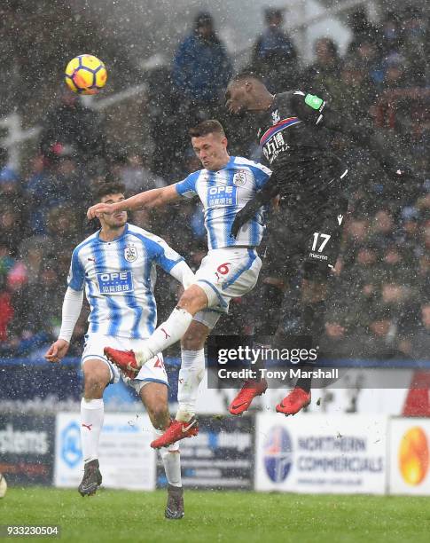 Jonathan Hogg of Huddersfield Town challenges Christian Benteke of Crystal Palace during the Premier League match between Huddersfield Town and...