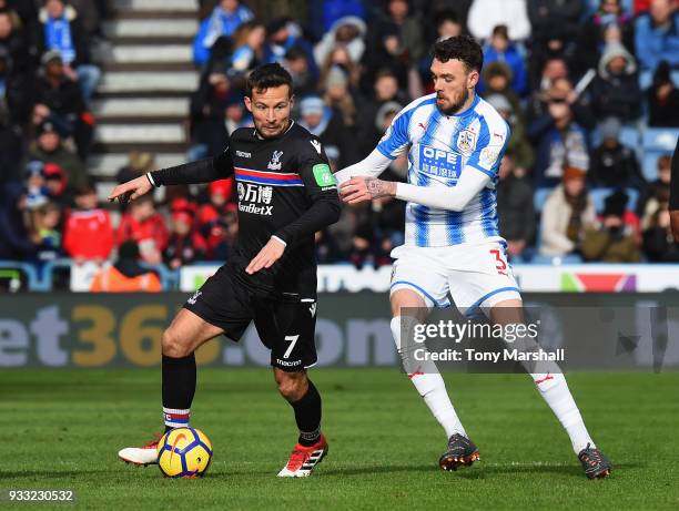 Scott Malone of Huddersfield Town challenges Yohan Cabaye of Crystal Palace during the Premier League match between Huddersfield Town and Crystal...