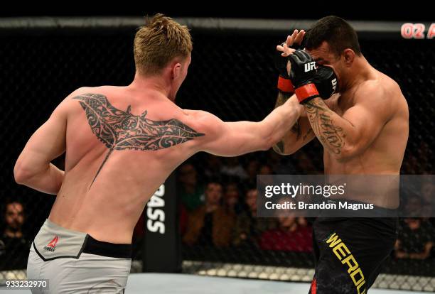 Alexander Volkov of Russia punches Fabricio Werdum of Brazil in their heavyweight bout inside The O2 Arena on March 17, 2018 in London, England.