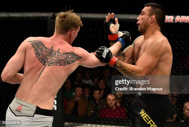 Alexander Volkov of Russia punches Fabricio Werdum of Brazil in their heavyweight bout inside The O2 Arena on March 17, 2018 in London, England.