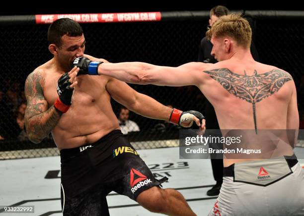 Alexander Volkov of Russia punches Fabricio Werdum of Brazil in their heavyweight bout inside The O2 Arena on March 17, 2018 in London, England.