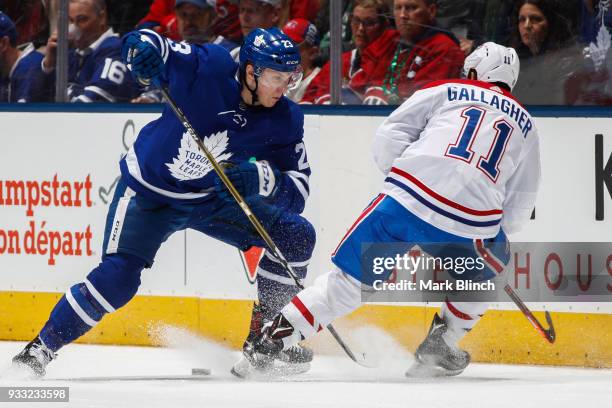 Travis Dermott of the Toronto Maple Leafs skates against Brendan Gallagher of the Montreal Canadiens during the first period at the Air Canada Centre...