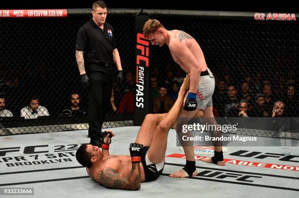 Alexander Volkov of Russia stands over Fabricio Werdum of Brazil in their heavyweight bout inside The O2 Arena on March 17, 2018 in London, England.