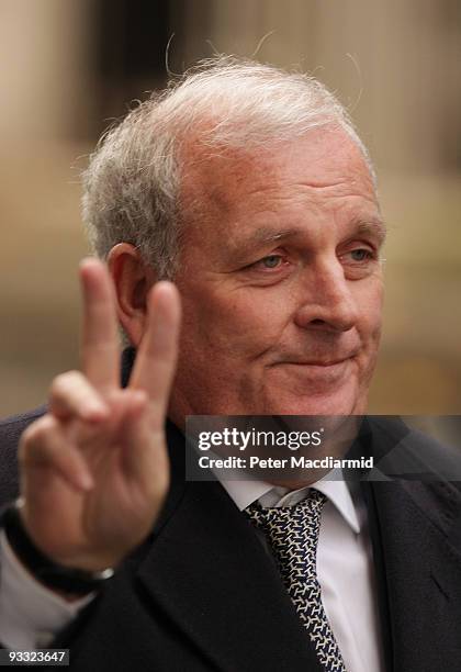 Former editor of The Sun newspaper Kelvin MacKenzie gestures to photographers as he leaves Downing Street on November 23, 2009 in London. Guests...