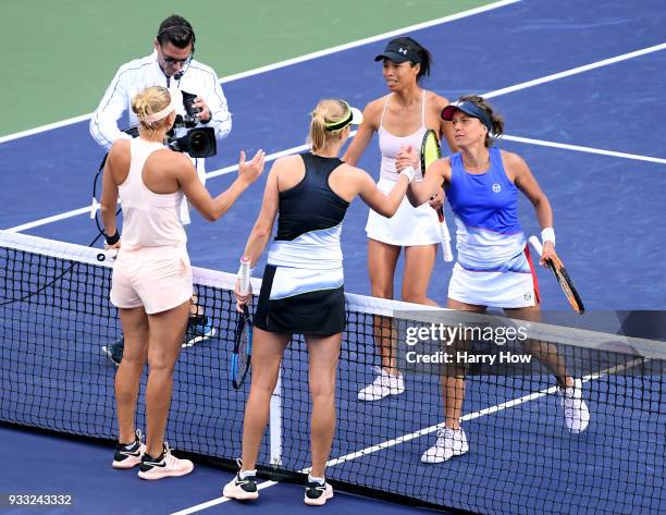 Barbora Strycova of the Czech Republic and Su-Wei Hsieh of Chinese Tapei shake hands with Ekaterina Makarova and Elena Vesnina of Russia after...