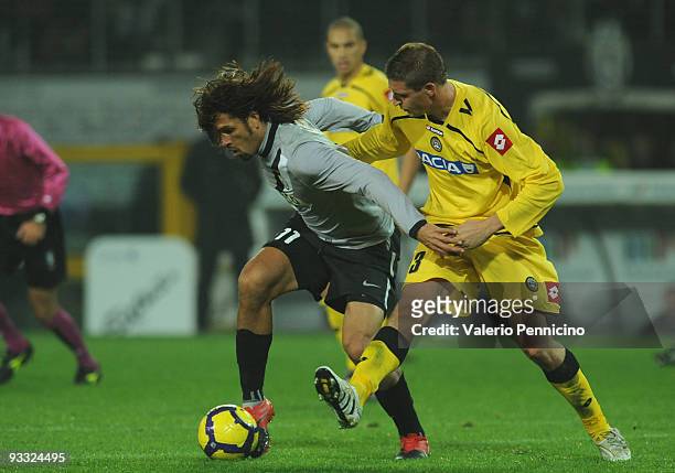 Carvalho De Oliveira Amauri of Juventus FC is challenged by Andrea Coda of Udinese Calcio during the Serie A match between Juventus and Udinese at...