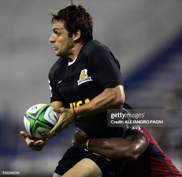 Argentina's Jaguares fly half Nicolas Sanchez is tackled by Australia's Reds centre Samu Kerevi during their Super Rugby match at the Jose Amalfitani...