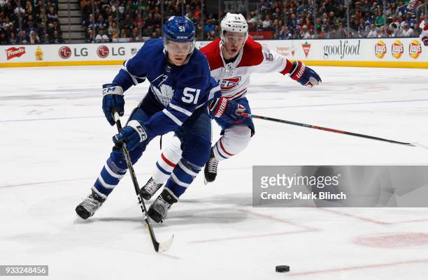 Jake Gardiner of the Toronto Maple Leafs skates against Charles Hudon of the Montreal Canadiens during the first period at the Air Canada Centre on...