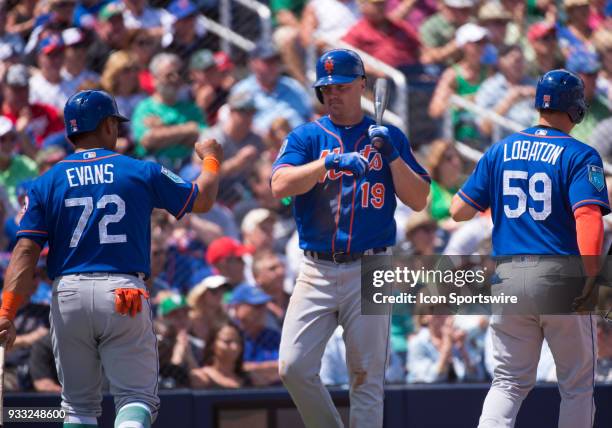 New York Mets Non-Roster Invitee Infielder Phillip Evans and New York Mets Non-Roster Invitee Catcher Jose Lobaton celebrate scoring runs with New...