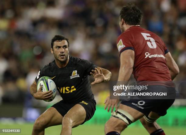 Argentina's Jaguares half scrum Felipe Ezcurra protects the ball from Australia's Reds lock Kane Douglas during their Super Rugby match at the Jose...