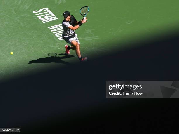 Borna Coric of Croatia returns a backhand in his quarterfinal match against Kevin Anderson of South Africa during the BNP Paribas Open at the Indian...