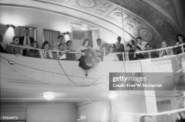 American cellist and performance artist Charlotte Moorman plays cello from the balcony of Judson Hall as part of a performance of Karlheinz...