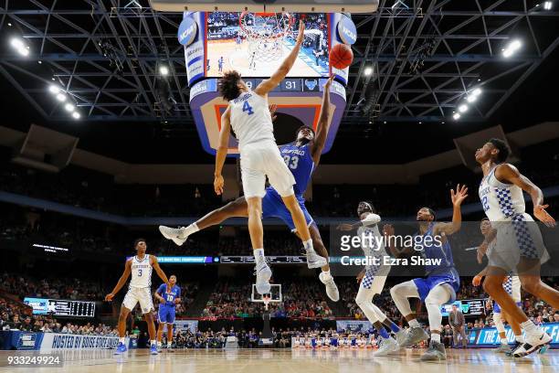 Nick Richards of the Kentucky Wildcats blocks a shot by Nick Perkins of the Buffalo Bulls during the first half in the second round of the 2018 NCAA...