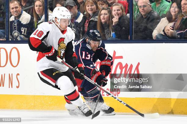 Ryan Dzingel of the Ottawa Senators and Cam Atkinson of the Columbus Blue Jackets battle for control of the puck in the second period on March 17,...