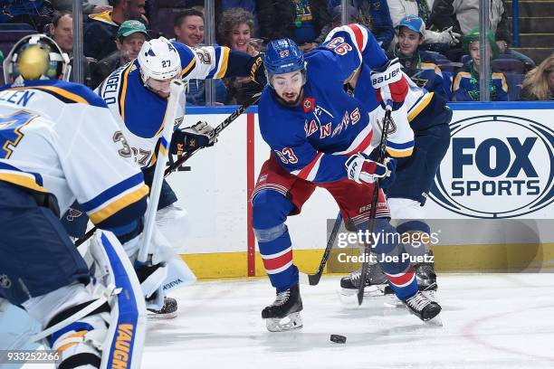 Alex Pietrangelo of the St. Louis Blues defends against Mika Zibanejad of the New York Rangers at Scottrade Center on March 17, 2018 in St. Louis,...