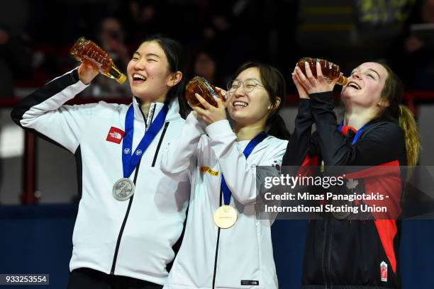 Suk Hee Shim of Korea , Min Jeong Choi of Korea and Kim Boutin of Canada hold up their bottles of maple syrup during the medal ceremony after...