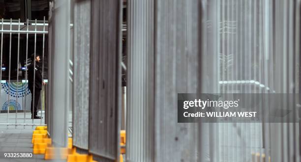 This photo taken on March 14, 2018 shows a security guard standing outside the International Convention Centre in Sydney which hosts a special summit...