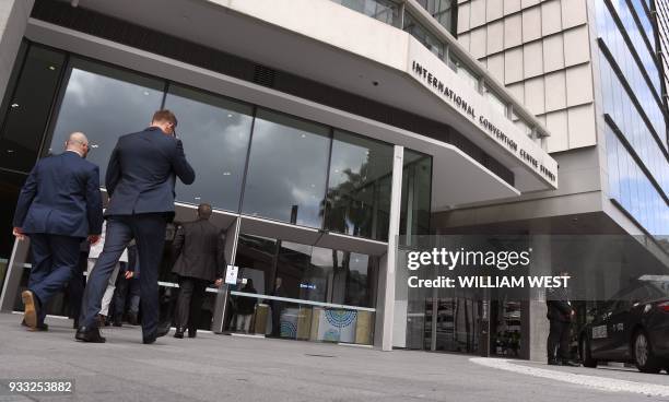 This photo taken on March 14, 2018 shows police entering the International Convention Centre in Sydney which hosts a special summit with leaders from...