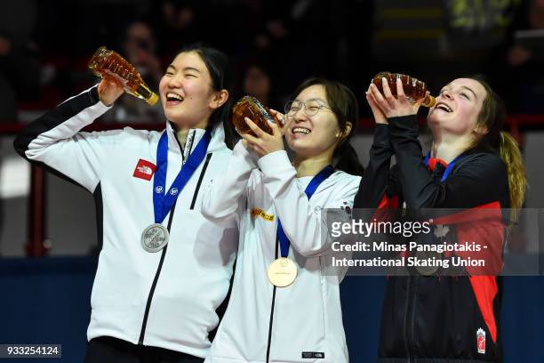 Suk Hee Shim of Korea , Min Jeong Choi of Korea and Kim Boutin of Canada hold up their bottles of maple syrup during the medal ceremony after...