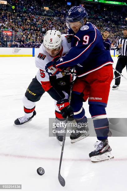 Artemi Panarin of the Columbus Blue Jackets and Cody Ceci of the Ottawa Senators battle for control of the puck during the second period on March 17,...