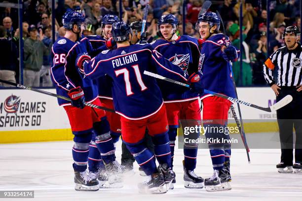 Nick Foligno of the Columbus Blue Jackets skates over to congratulate Markus Nutivaara of the Columbus Blue Jackets on scoring a power-play goal...