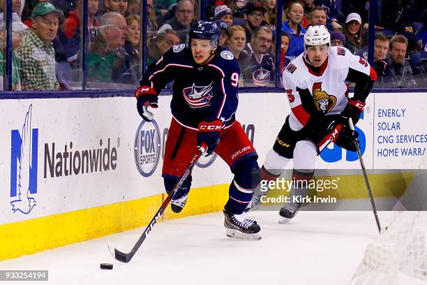 Artemi Panarin of the Columbus Blue Jackets skates the puck away from Cody Ceci of the Ottawa Senators during the second period on March 17, 2018 at...