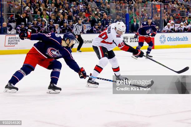 Oliver Bjorkstrand of the Columbus Blue Jackets attempts to steal the puck from Jim O'Brien of the Ottawa Senators during the second period on March...