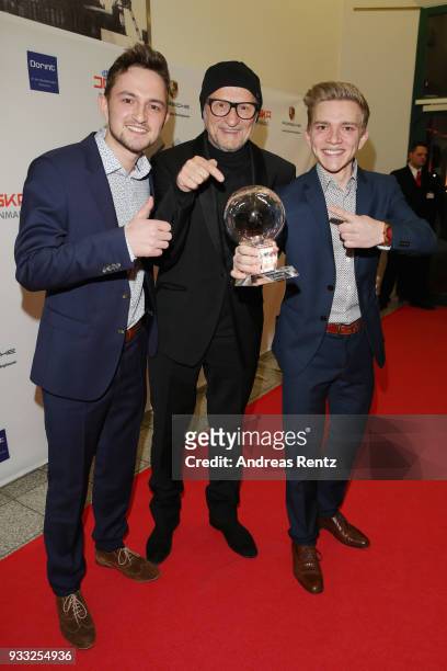 Musicians Markus Danninger and his brother Thomas Danninger pose with their award while laudator Titus Dittmann smiles during the Steiger Award at...