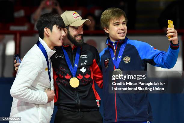 Hyo Jun Lim of Korea and Charles Hamelin of Canada pose for a selfie photo with Semen Elistratov of Russia after completing the men's 1500 meter...