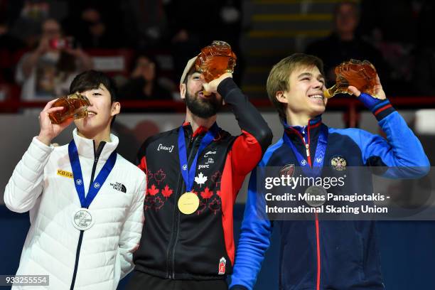 Hyo Jun Lim of Korea , Charles Hamelin of Canada and Semen Elistratov of Russia hold up their bottles of maple syrup during the medal ceremony after...
