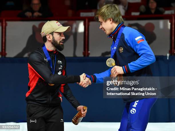 Gold medal winner of the men's 1500 meter Final Charles Hamelin of Canada , shakes the hand of the bronze medal winner Semen Elistratov of Russia ,...