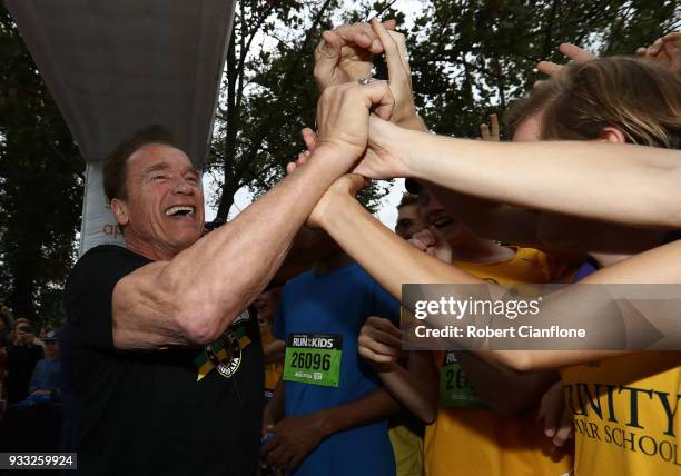 Arnold Schwarzenegger greets runners as he prepares to start the Run for the Kids charity run as part of the Arnold Sports Festival Australia at at...